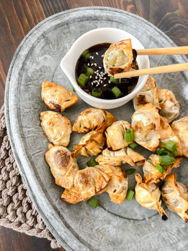 Air Fryer Mini Wontons being dipped into sauce