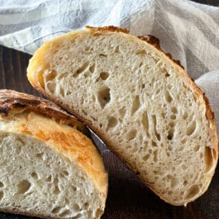 2 sourdough loaves cut open to reveal the crumb